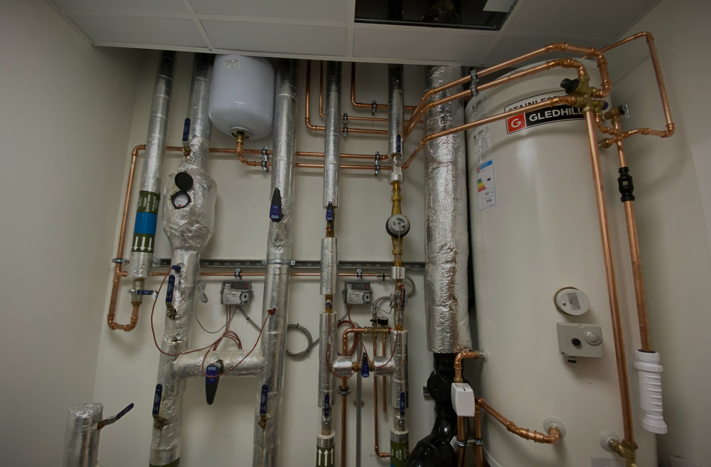 Commercial plant room with insulated copper pipework and a Gledhill stainless unvented hot water cylinder